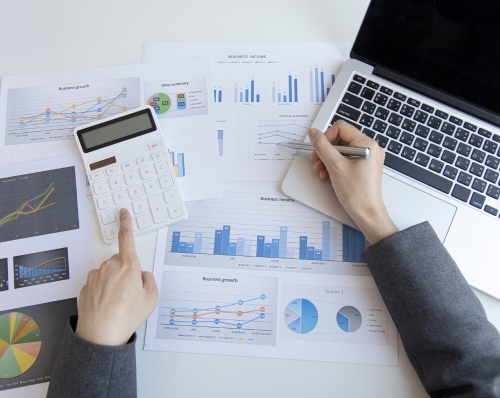 About Home image featuring people checking charts.